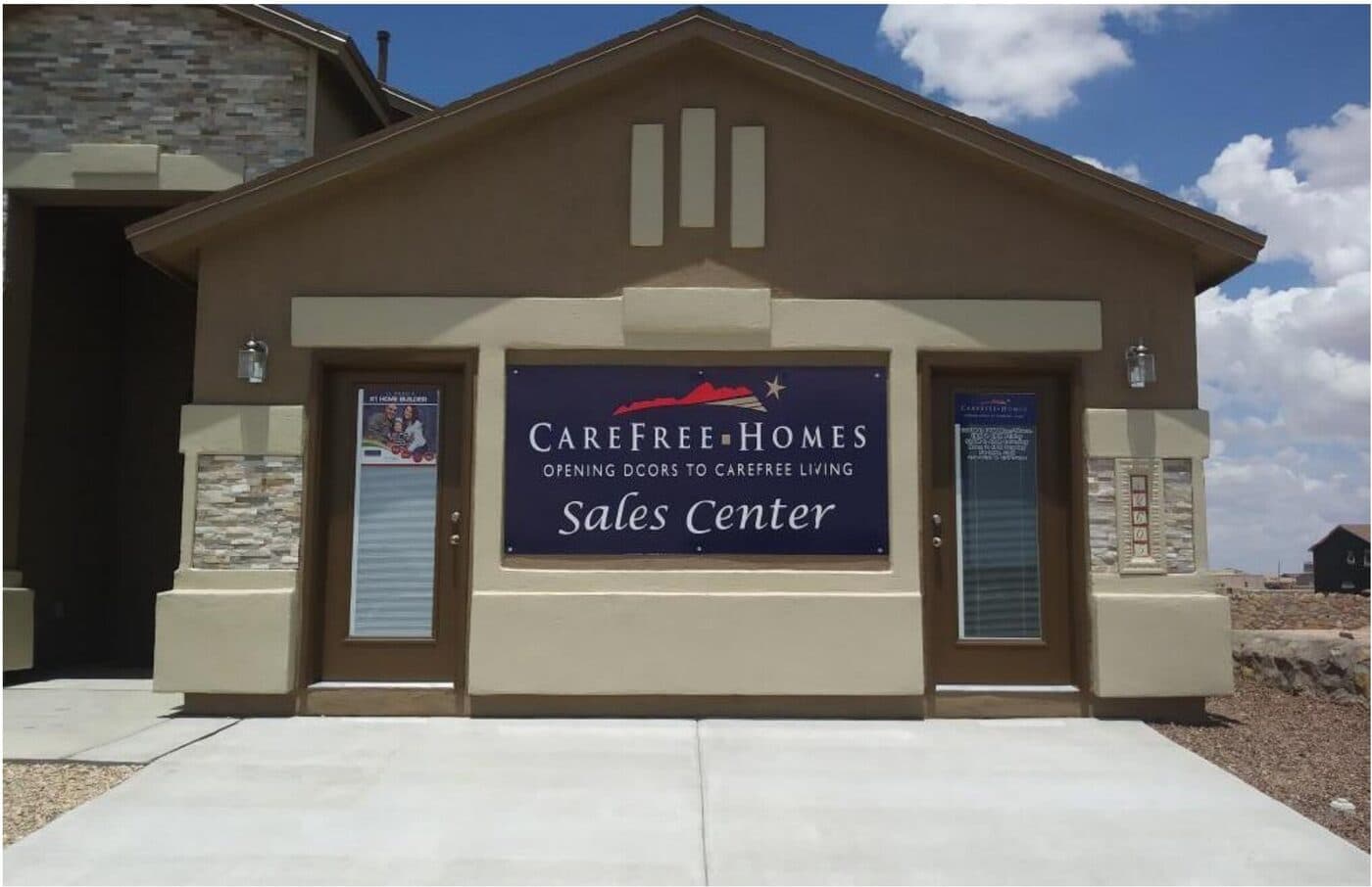Full-color sales center banner mounted on a model home facade