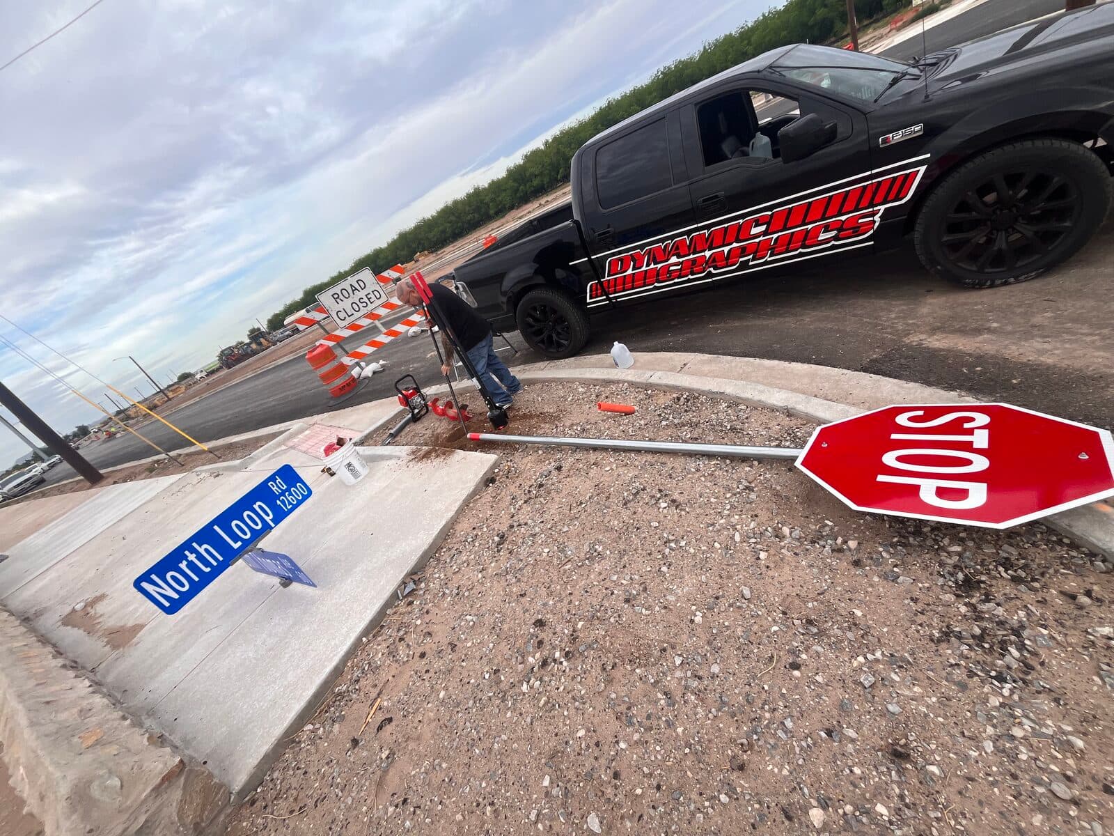 Dynamic Graphics work truck with red cut-vinyl lettering on the job